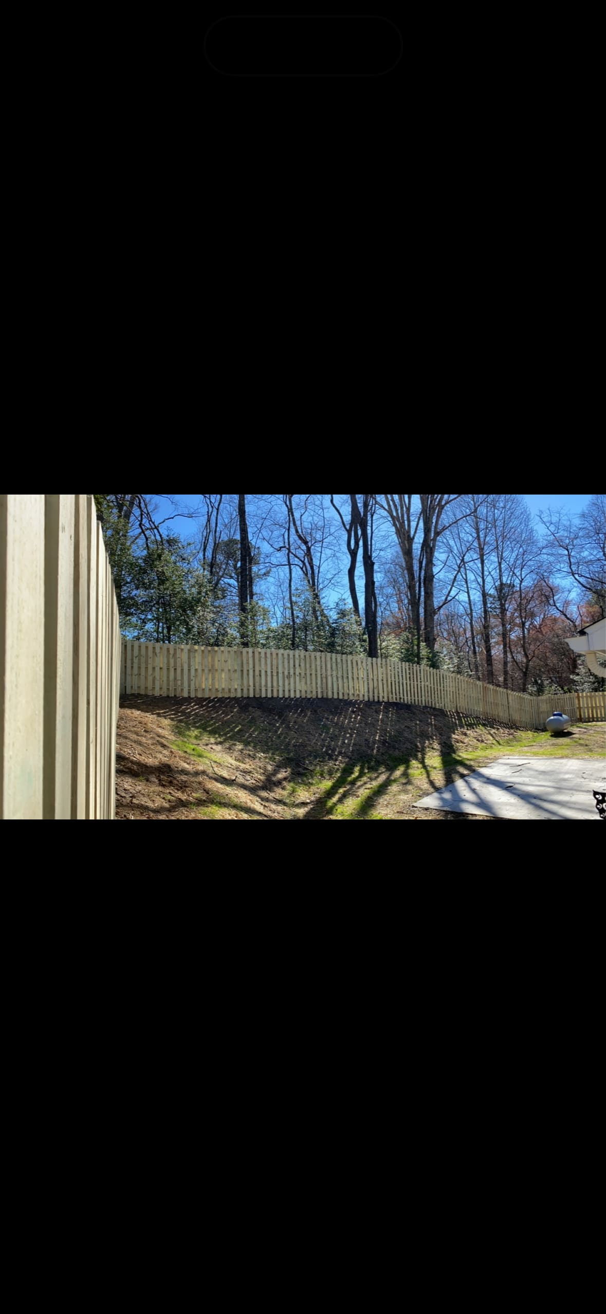 Newly built wood shadowbox privacy fence installed by Fleming Fencing along a wooded north Georgia backyard